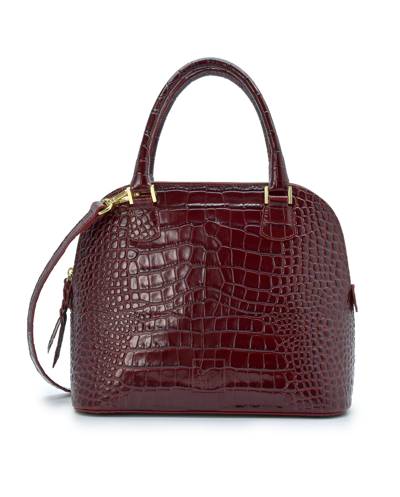 Imagen frontal de bolso de mano de piel grabada en coco color burdeos Leandra.
